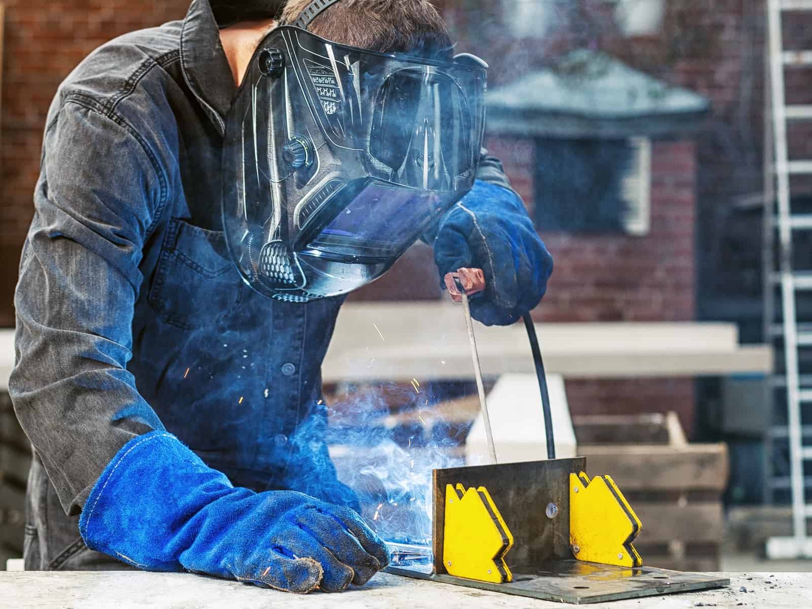 man stick welding outside